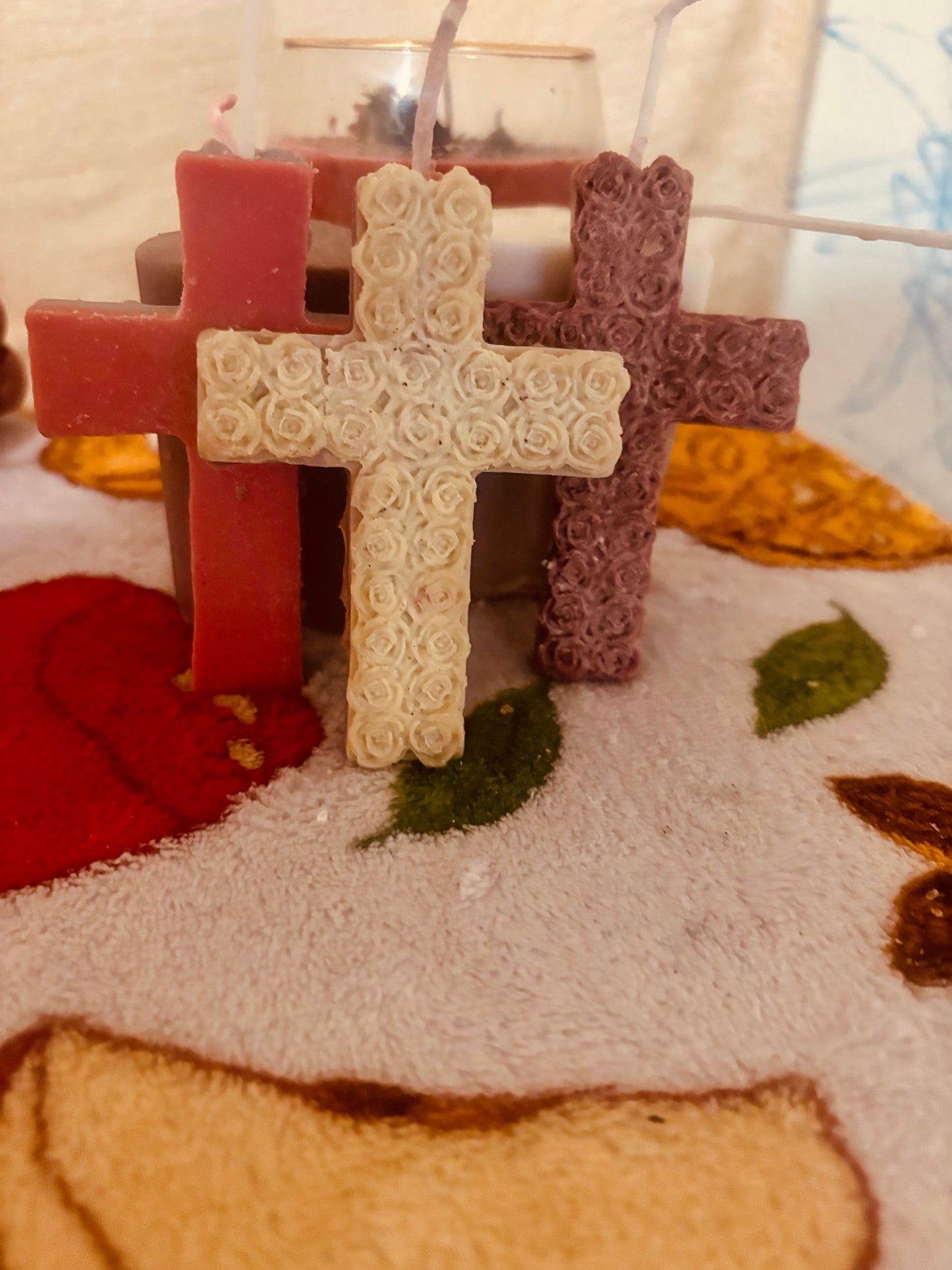 Cross candle covered in beautiful roses.