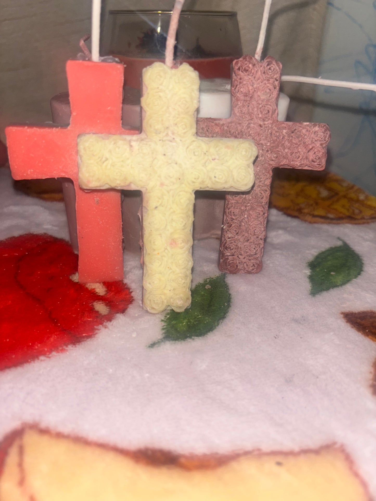 Cross candle covered in beautiful roses.